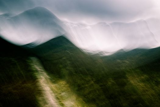 Moody abstract landscape photography featuring ethereal mountain ridges and mist in the Scottish Highlands.