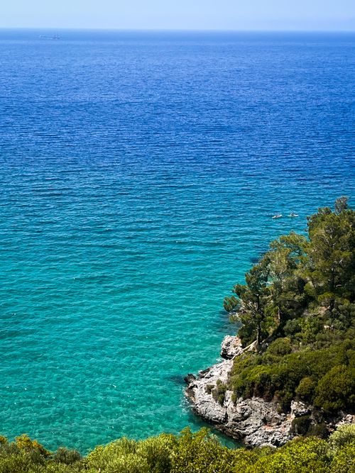 Free A breathtaking view of the turquoise Aegean Sea along the rugged coastline of Kuşadası in Türkiye. Stock Photo