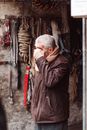 Mature faceless man rubbing face in garage