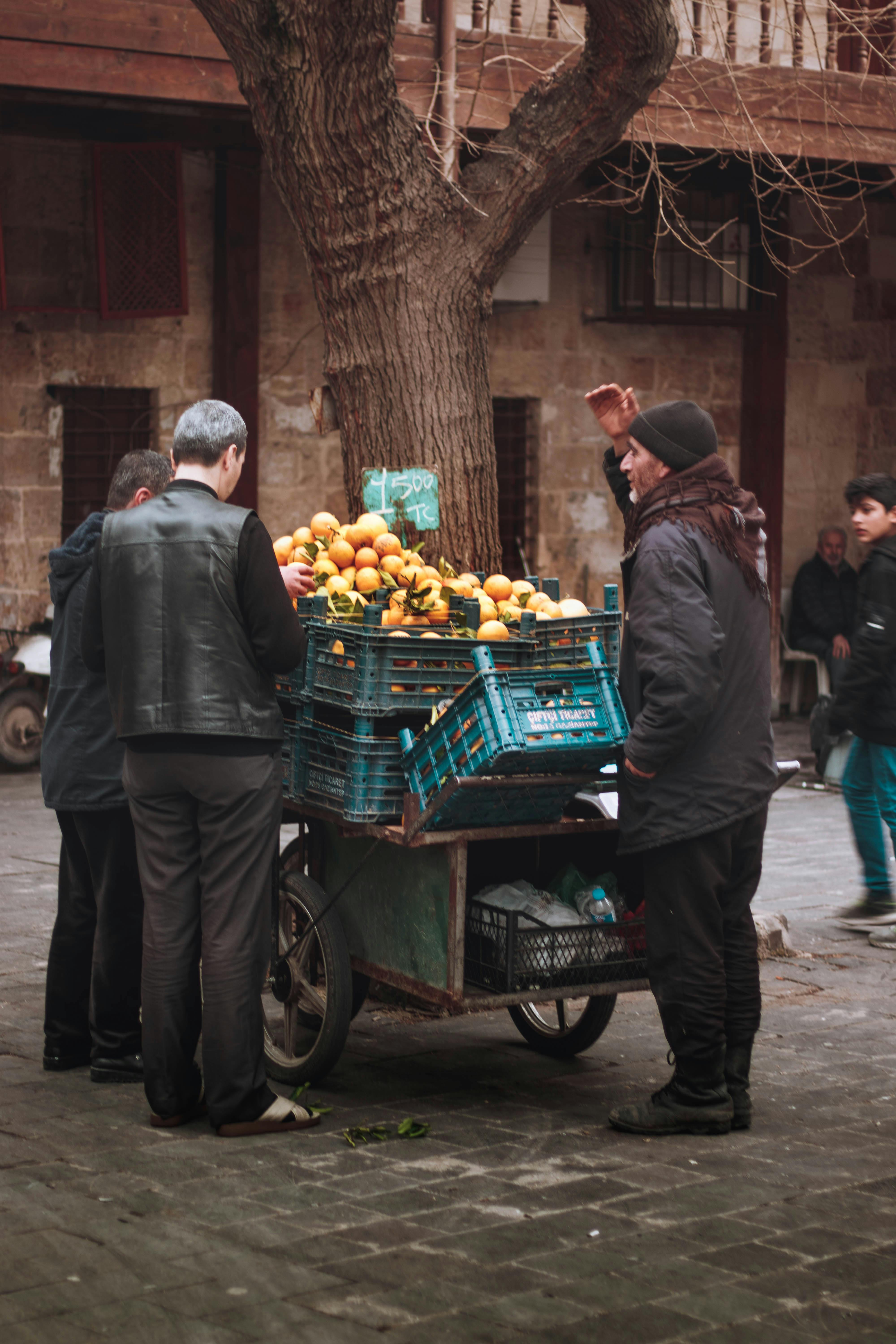 old man selling fruits on street