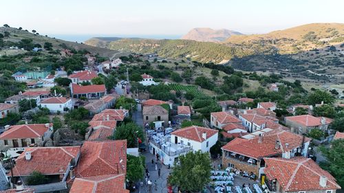 Free A stunning aerial view of a picturesque village in Gökçeada, Türkiye, featuring red-roofed houses and surrounding hills. Stock Photo