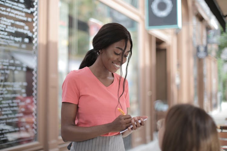 Photo Of Woman Taking Order From A Customer