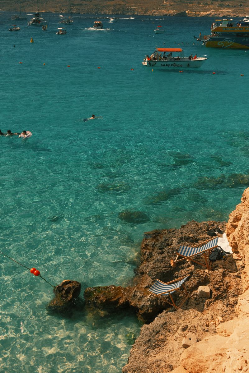 Sunny day at the rocky coast with turquoise waters in Gozo, Malta, perfect for a summer getaway.