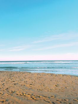 A serene view of a sandy beach and clear blue sky in Durban, KwaZulu-Natal, South Africa.