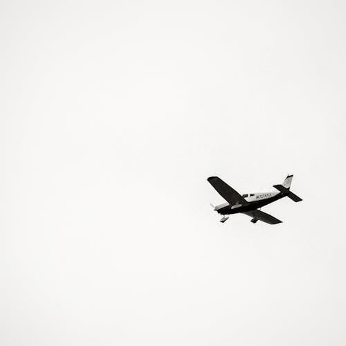 Free Black and White Airplane in Mid Air Stock Photo