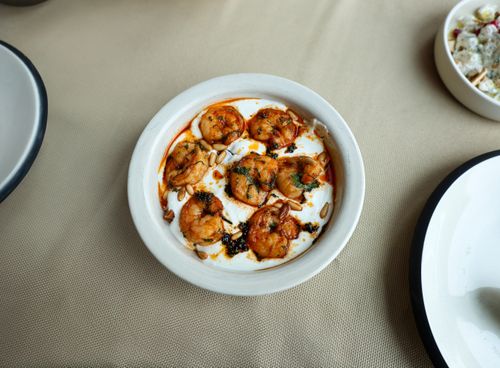 Free Appetizing shrimp dish served with spices and pine nuts in a creamy sauce, perfect for dining occasions. Stock Photo