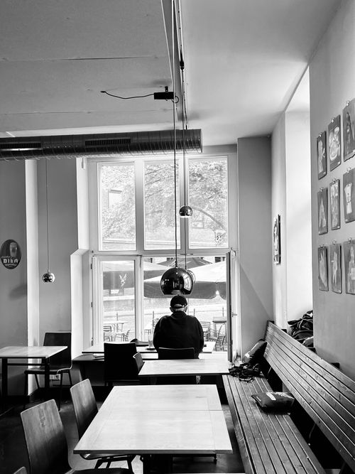 Free A solitary figure seated in a stylish cafe in Aachen, Germany. Stock Photo