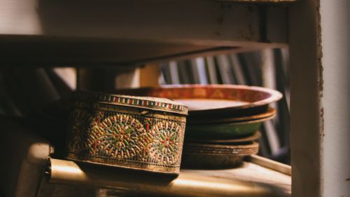 Free Decorative tin box with intricate patterns on a shelf, capturing vintage charm in Blida, Algeria. Stock Photo