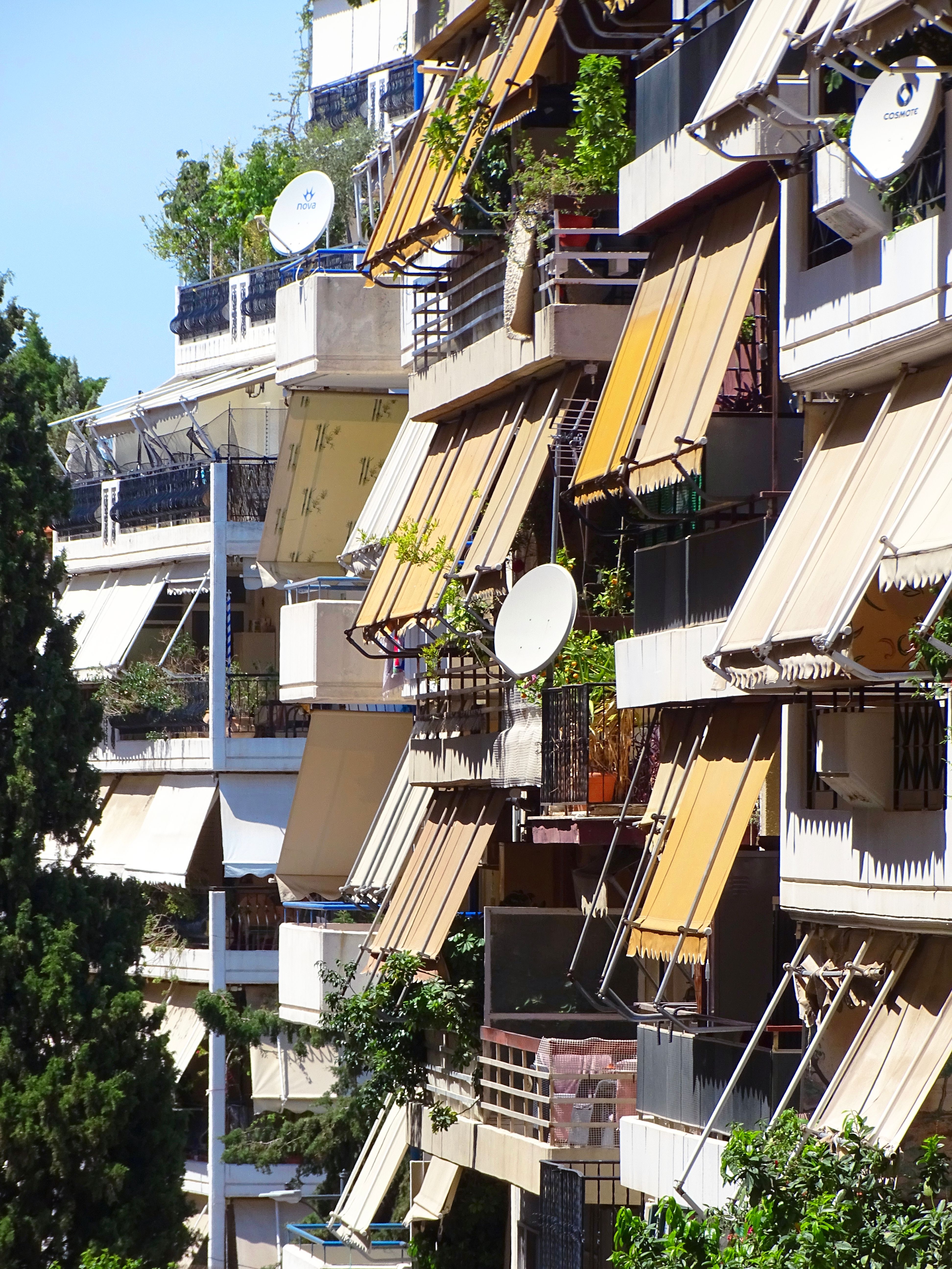 A row of brick apartment buildings on a residential street in a British town