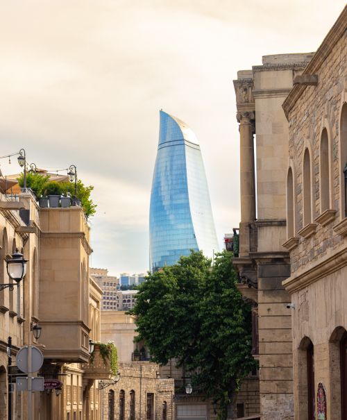 Free Scenic view of Baku's historic architecture and the modern Flame Tower against a serene sky. Stock Photo