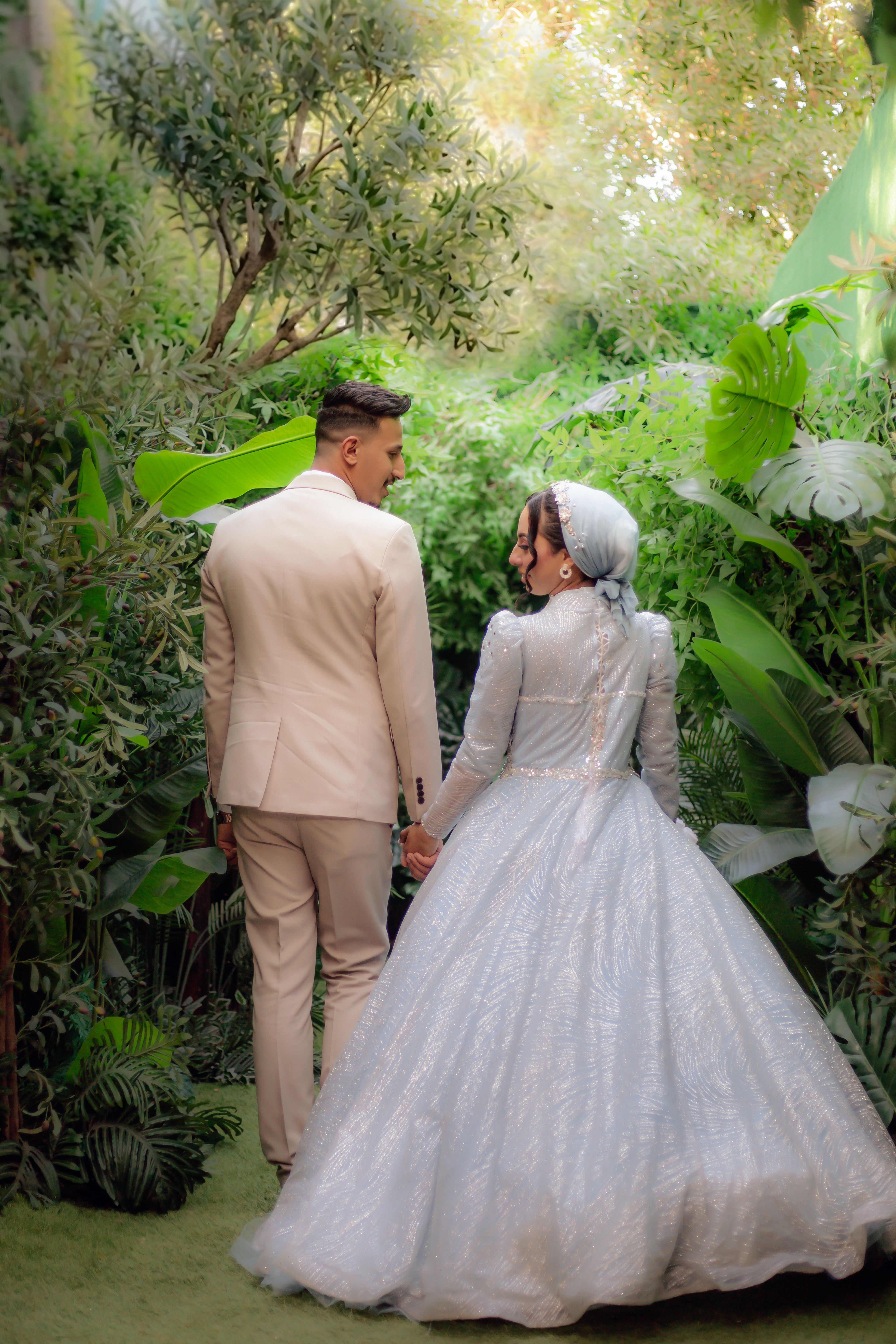 Elegant bride and groom in lush garden setting, ideal for romantic and wedding themes.