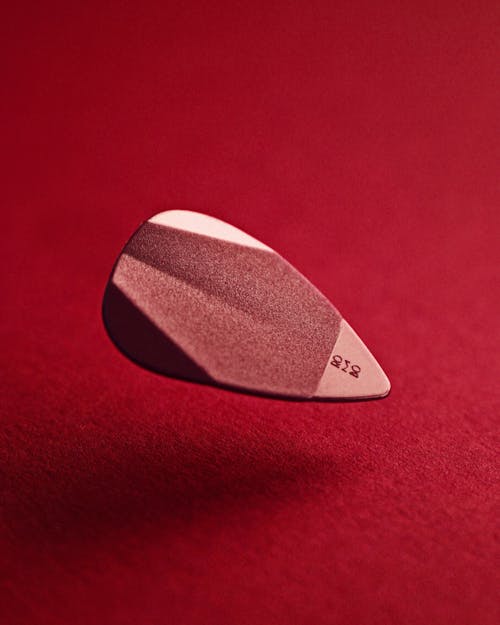 Guitar Pick on Red Background