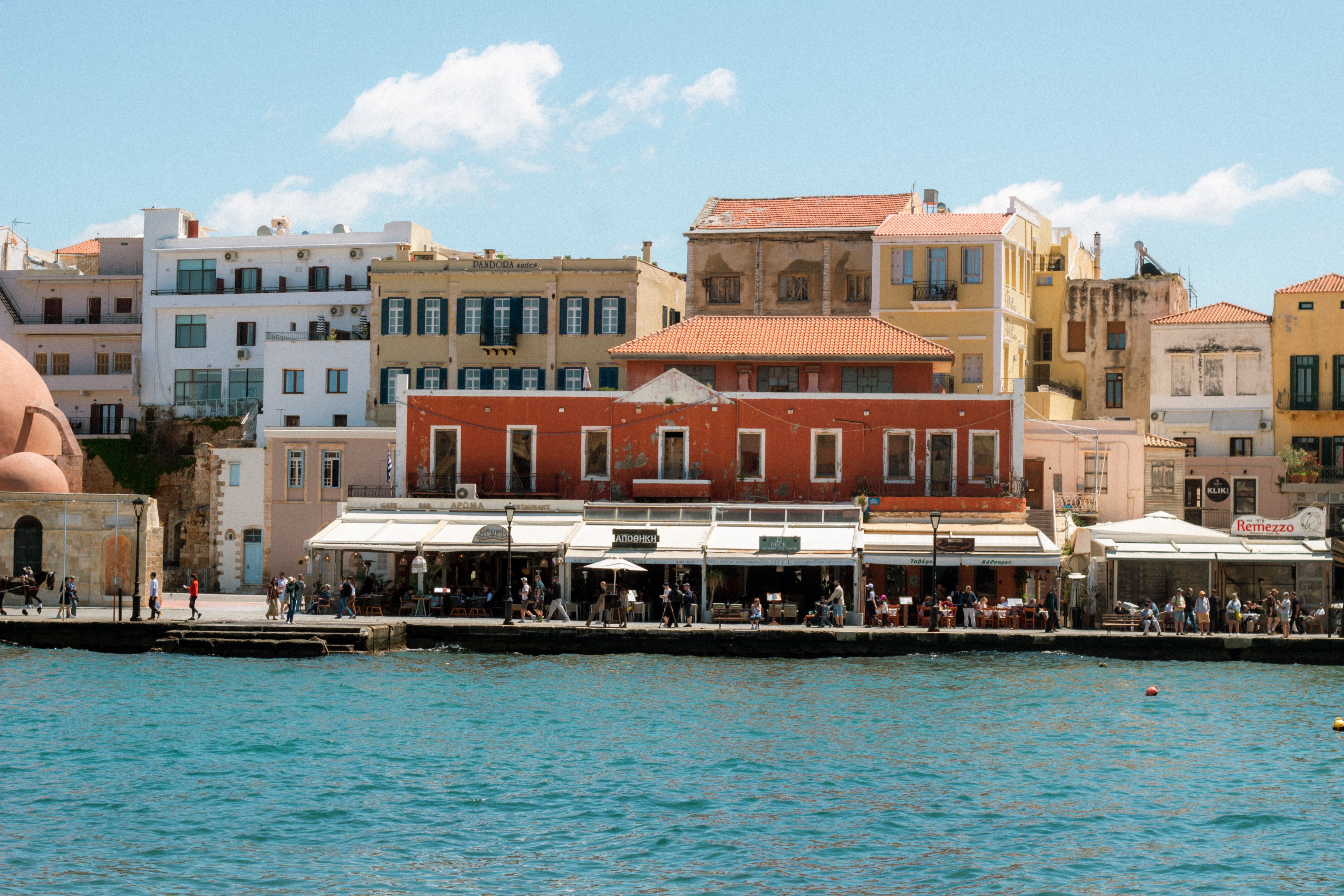 Explore the vibrant architecture of Chania's waterfront with its colorful buildings lining the harbor.