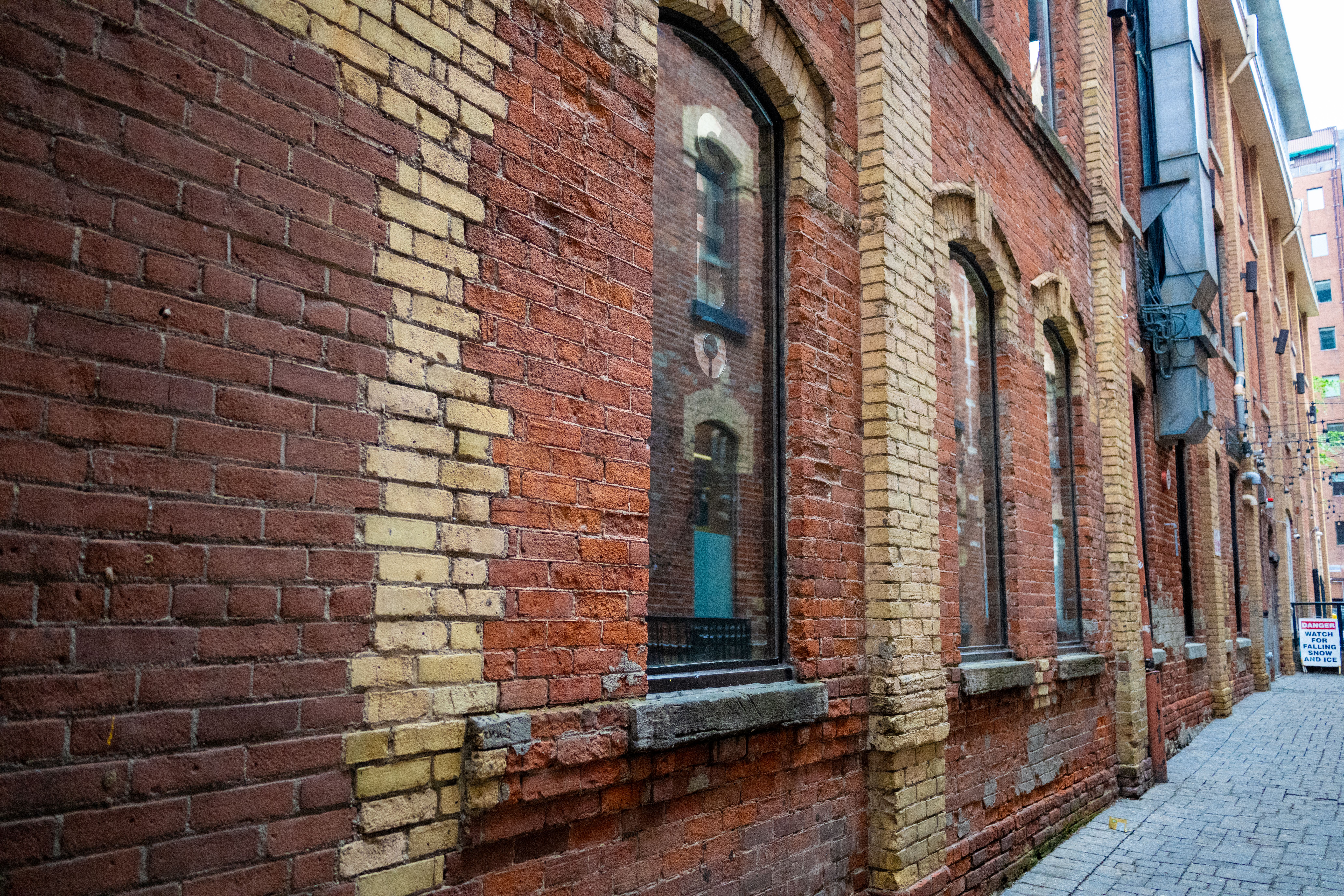 Detailed view of a historic brick alleyway showcasing urban architecture and texture.