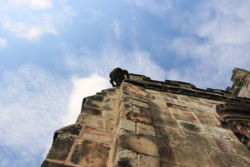 Free A dramatic view of a historic cathedral facade and gargoyle under a blue sky in England. Stock Photo