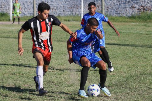 Free Intense soccer match with players competing for the ball on a sunny day. Stock Photo