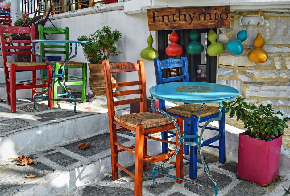 Outdoor cafe in Plaka, Athens, with a 'Free Wi-Fi' sign, showing a popular spot for internet access
