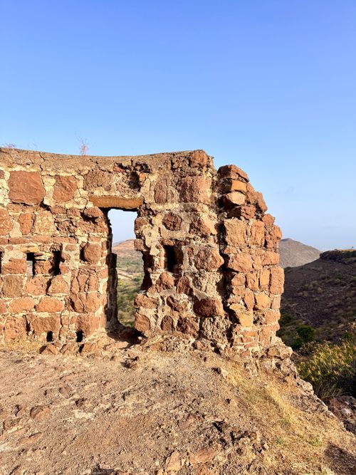 Free Explore ancient stone ruins with clear blue sky and rugged terrain. Ideal for history and travel themes. Stock Photo