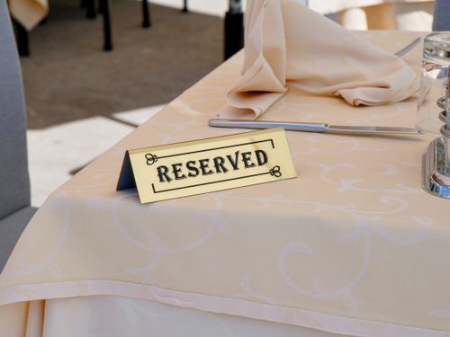 Free A close-up of a reserved table with elegant setting in an outdoor restaurant. Stock Photo