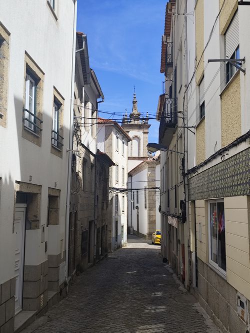 Free Picturesque view of a narrow cobblestone street lined with traditional houses in Gouveia, Portugal. Stock Photo