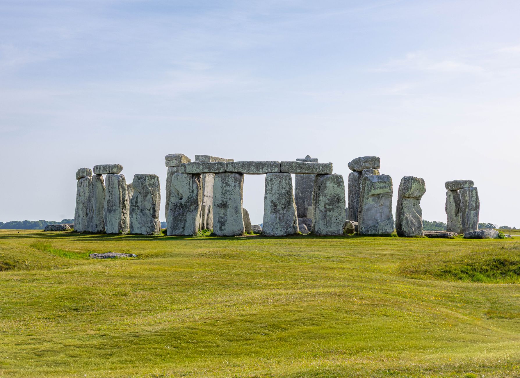 A stunning view of Stonehenge in Wiltshire, England, under a clear blue sky.