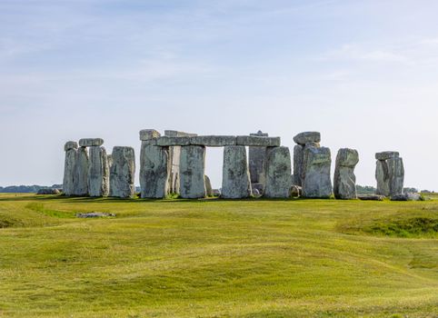 A stunning view of Stonehenge in Wiltshire, England, under a clear blue sky.