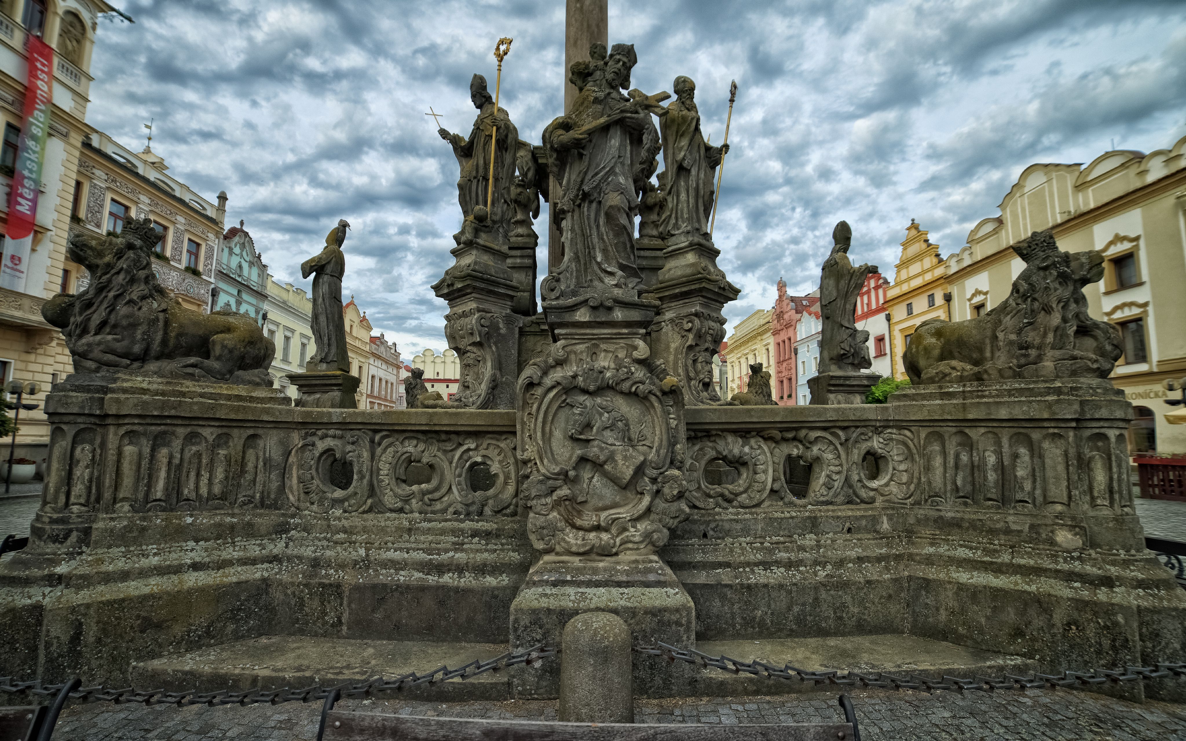 Ornate statues adorn a historic column in Pardubice's picturesque Old Town Square.