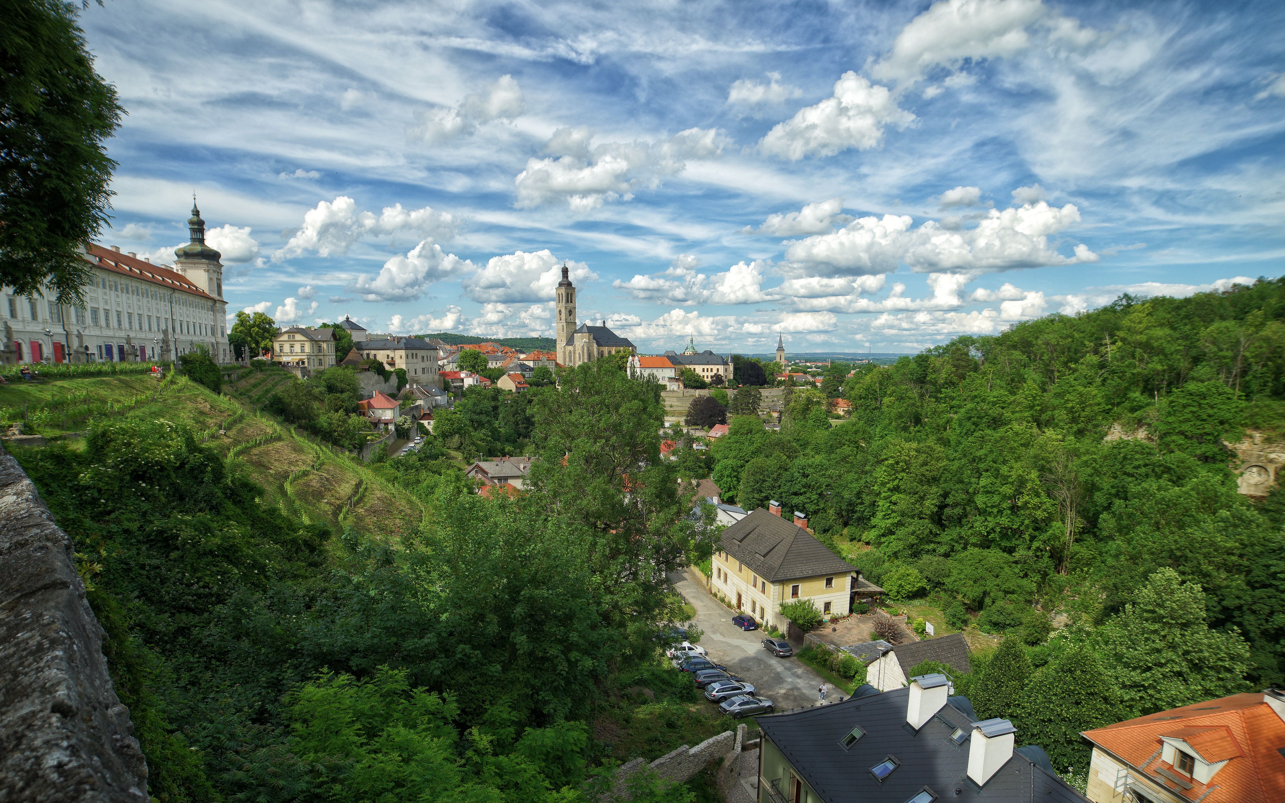 Scenic view of Kutna Hora with lush greenery under a bright sky.
