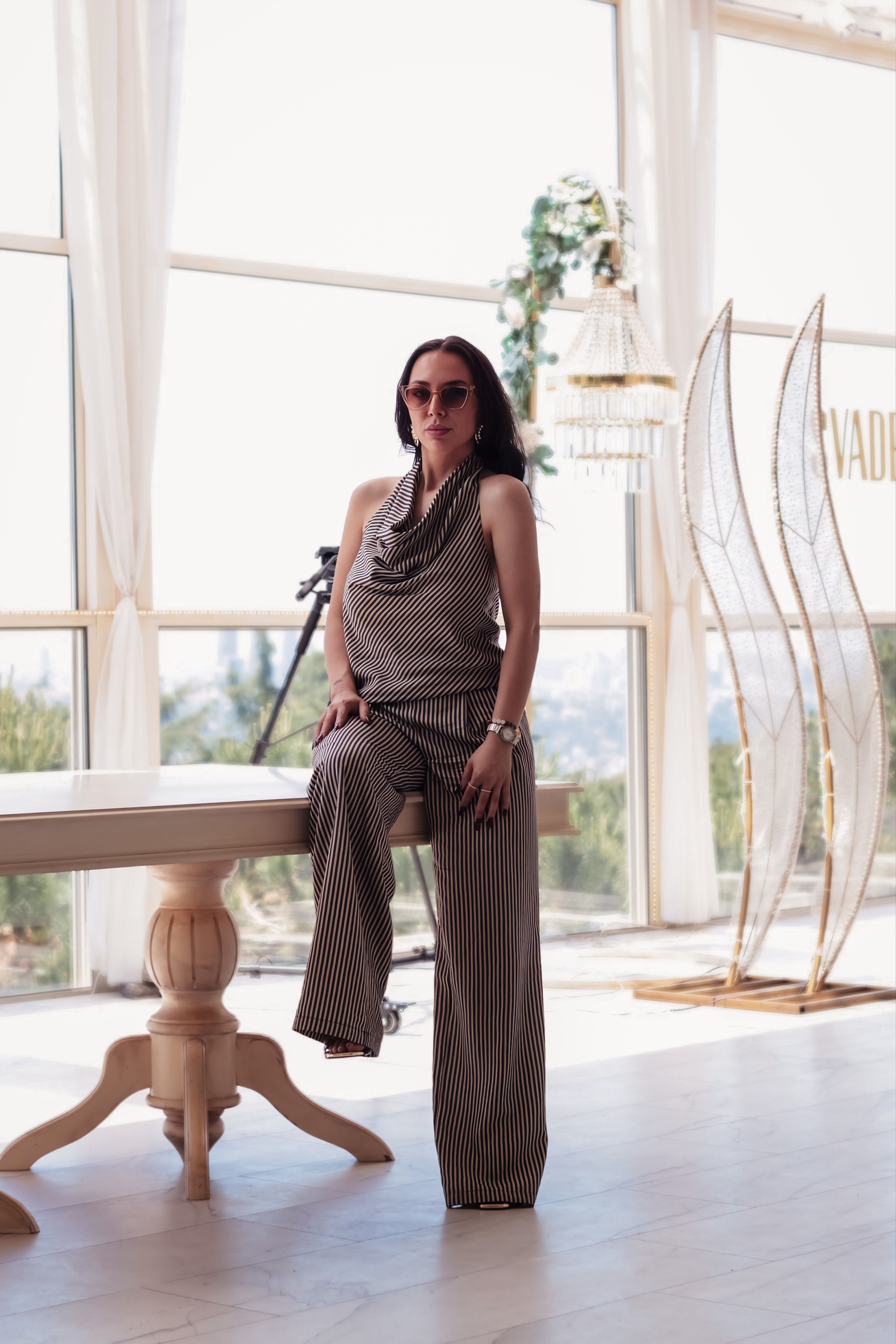 Modern Woman in Striped Jumpsuit with Sunglasses