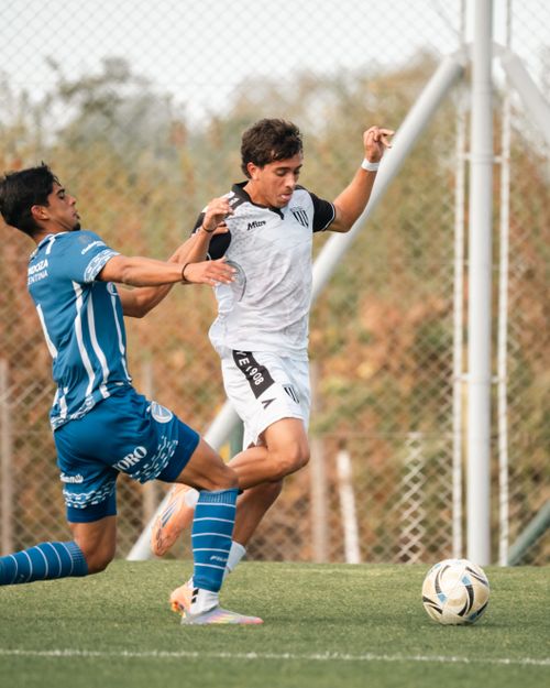 Free Two soccer players in intense action on a green field outdoors. Stock Photo