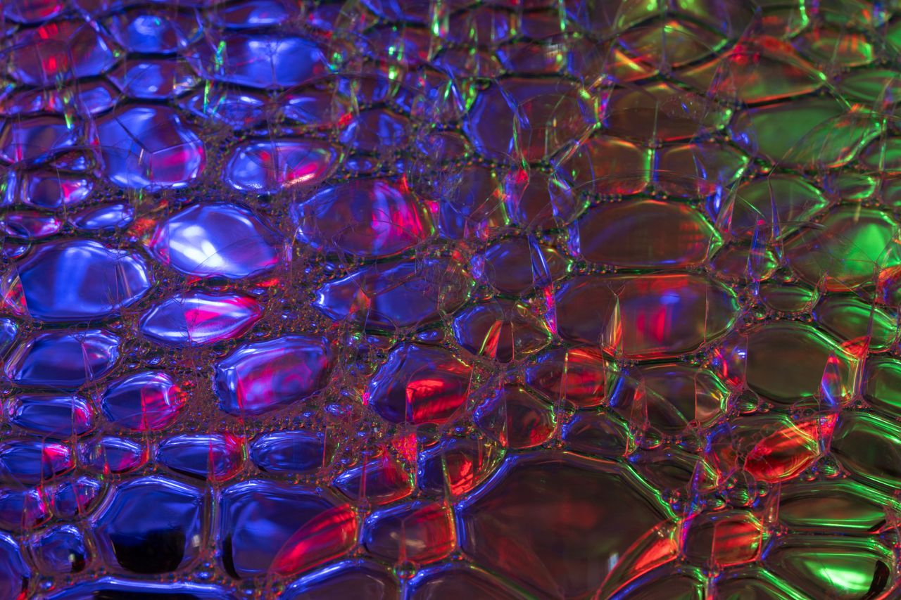vibrant abstract image of bubbles with neon lights reflecting in a col