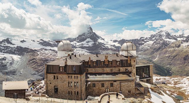 Stunning view of the Gornergrat Observatory with the Matterhorn in the background, showcasing the beauty of Zermatt, Switzerland.