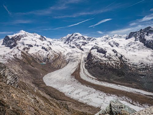 Free Breathtaking aerial view of the Gorner Glacier under clear blue skies in Zermatt, Switzerland. Stock Photo