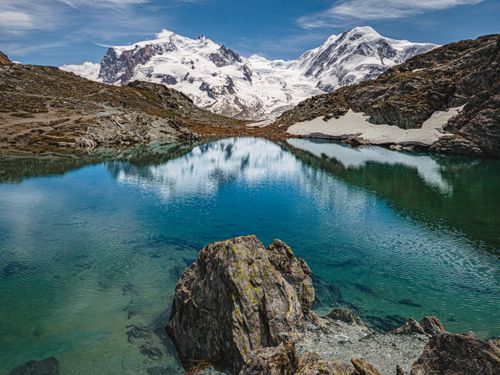 Free Scenic view of snow-capped mountains reflecting in a clear lake in Zermatt, Switzerland. Stock Photo