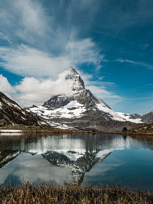 Free Breathtaking view of the Matterhorn peak reflecting in a serene mountain lake in Zermatt, Switzerland. Stock Photo