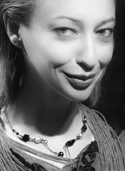 Elegant black and white portrait showcasing a woman's confident smile.