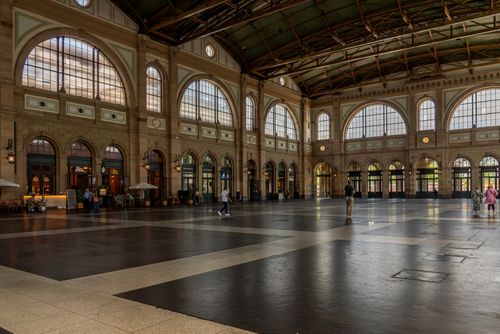 Free Elegant hall in a historic train station with few people around. Stock Photo