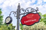 Ornate vintage clock and garden sign in Kaktus Bağı, Baku, Azerbaijan, evoking a classic charm.