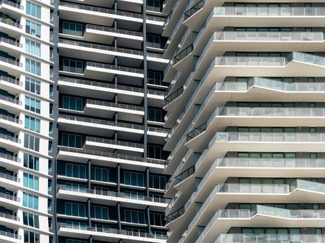 Close-up view of contemporary skyscrapers in Miami, showcasing geometric balconies and urban design.