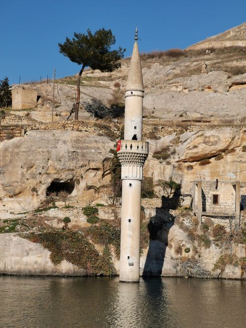 Free A scenic view of a partially submerged mosque minaret rising from the water in Halfeti, Turkey. Stock Photo