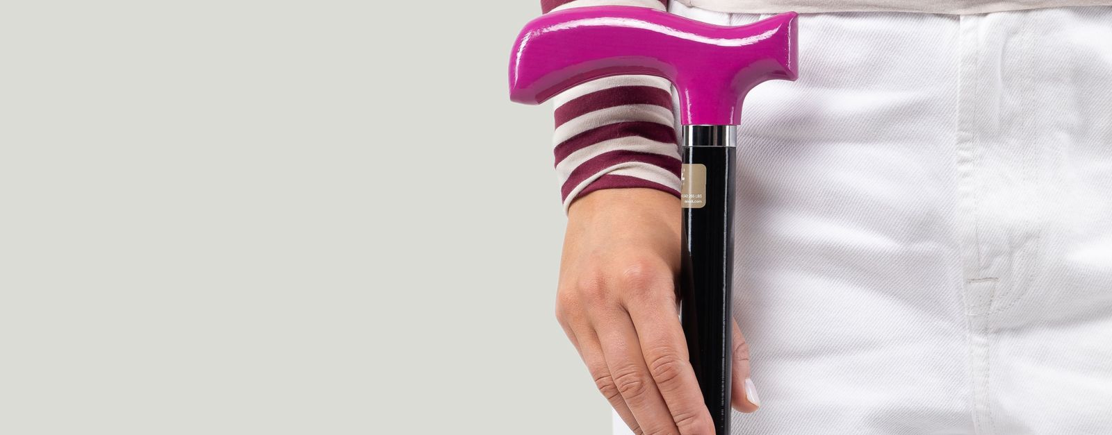 Elegant walking cane with pink handle showcasing adaptive fashion for stylish mobility solutions.