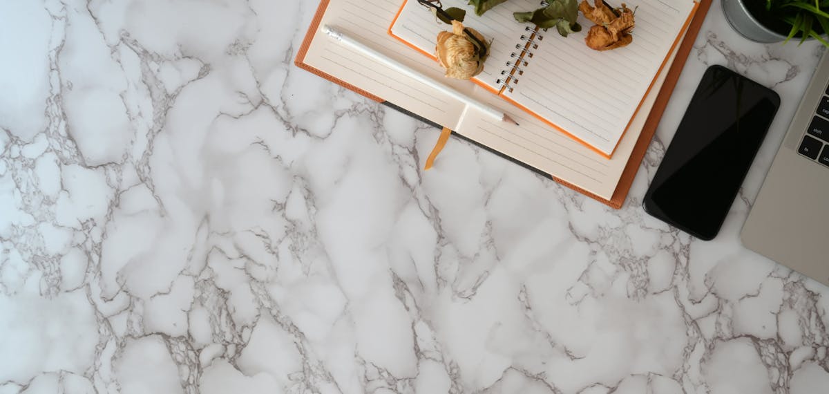 Person holding a book and a smartphone while choosing between reading and scrolling