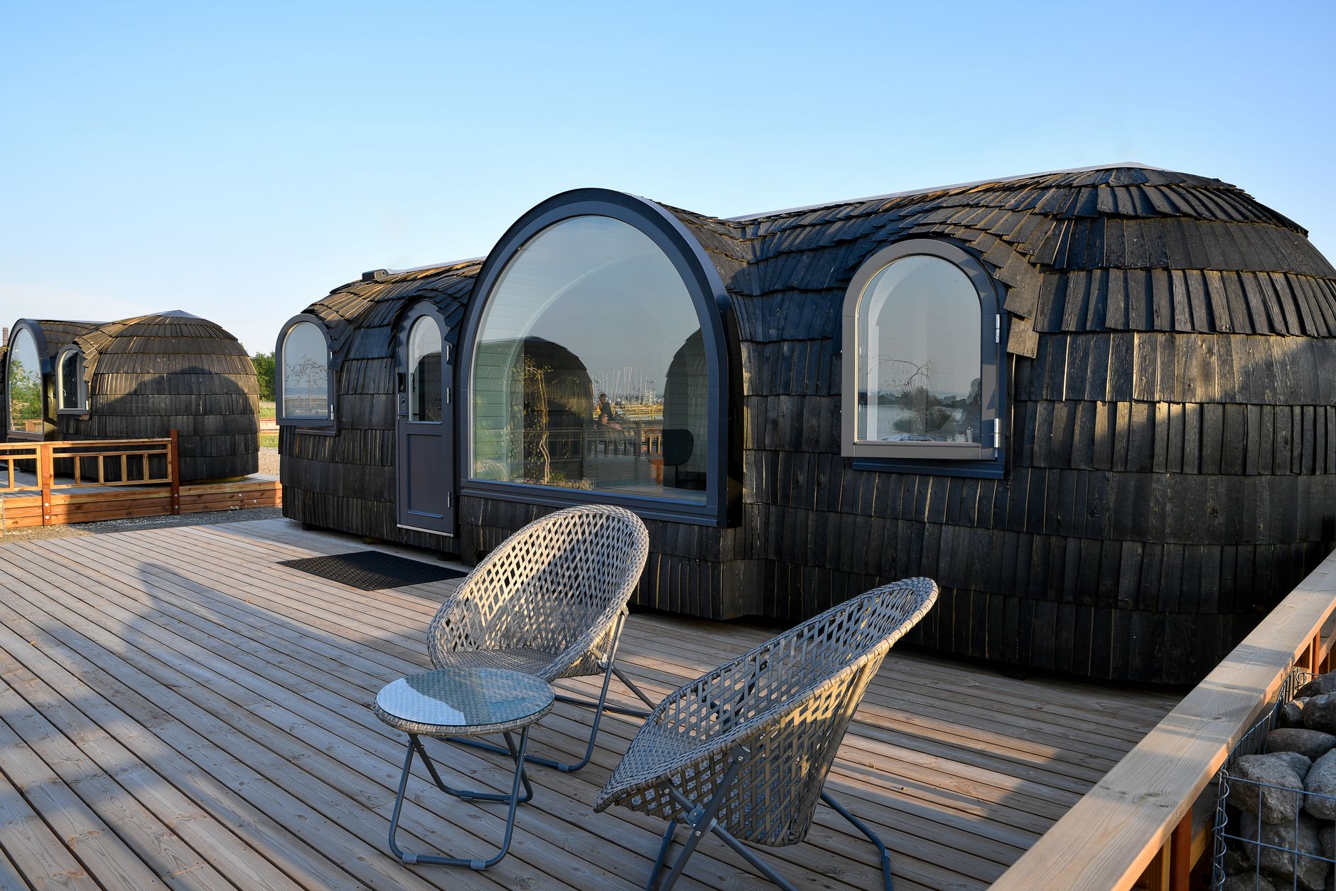 Eco-friendly glamping pods on a spacious wooden deck in Tallinn, Estonia. Perfect for a unique summer getaway.