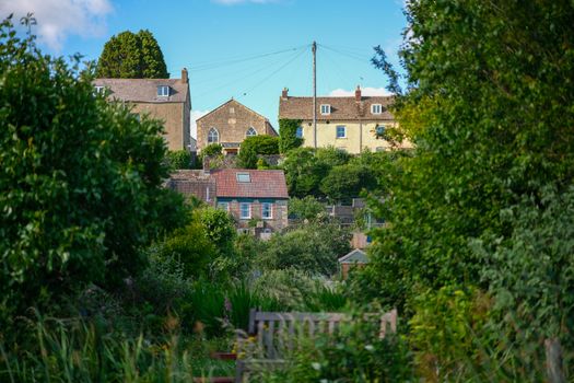 Scenic view of traditional houses set amidst lush greenery in Malmesbury, England.