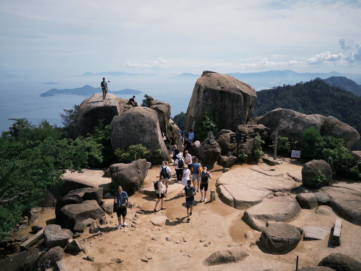 Hiker on a mountain trail in Japan surrounded by forest