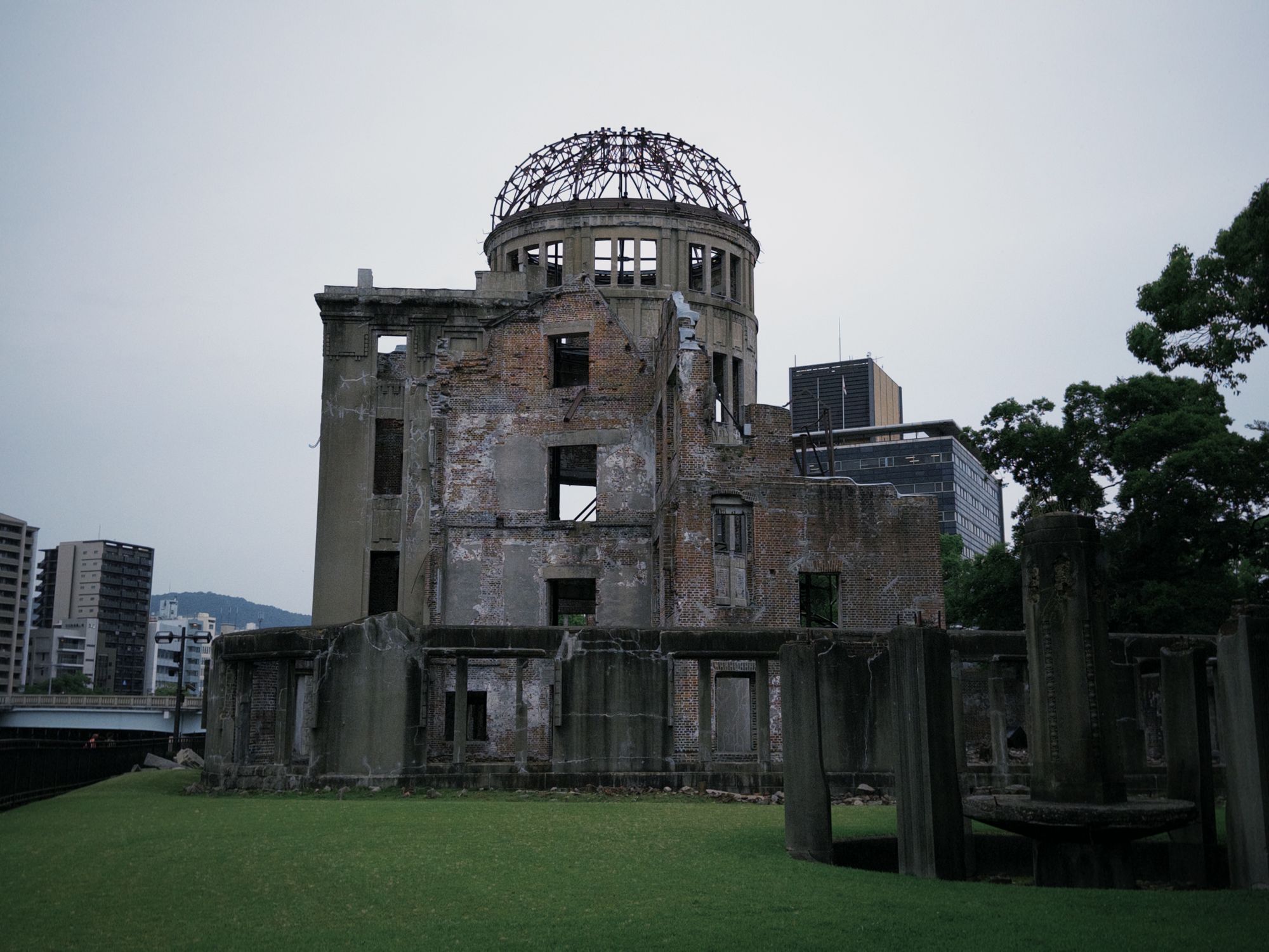Historic Hiroshima Atomic Bomb Dome with modern city backdrop.