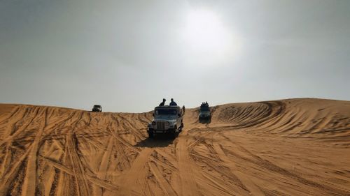 Free Off-road desert safari with Jeeps exploring the golden dunes of Rajasthan, India. Stock Photo