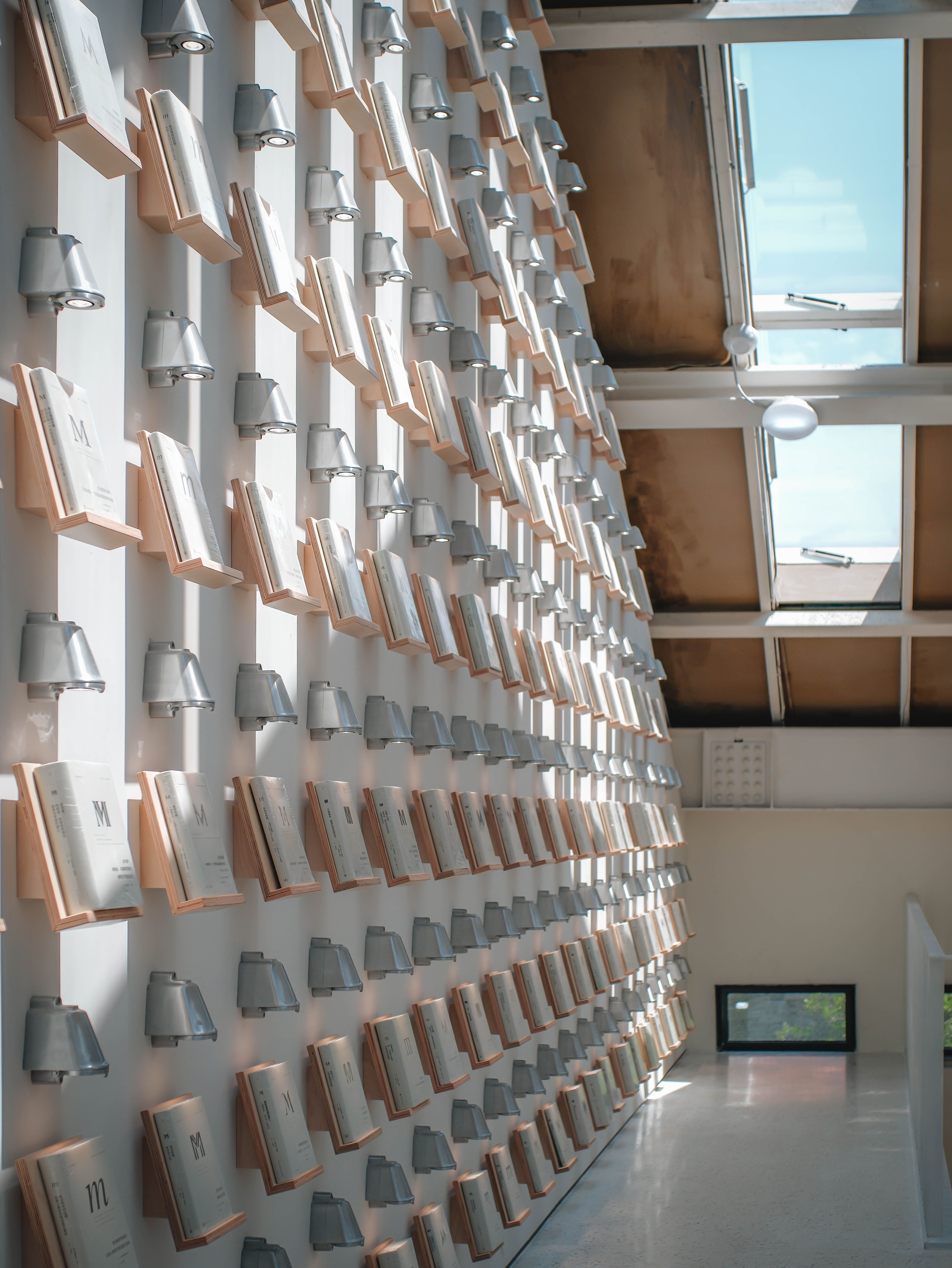 Unique wall design featuring open books under skylights, blending art and architecture.