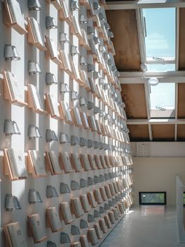 Unique wall design featuring open books under skylights, blending art and architecture.
