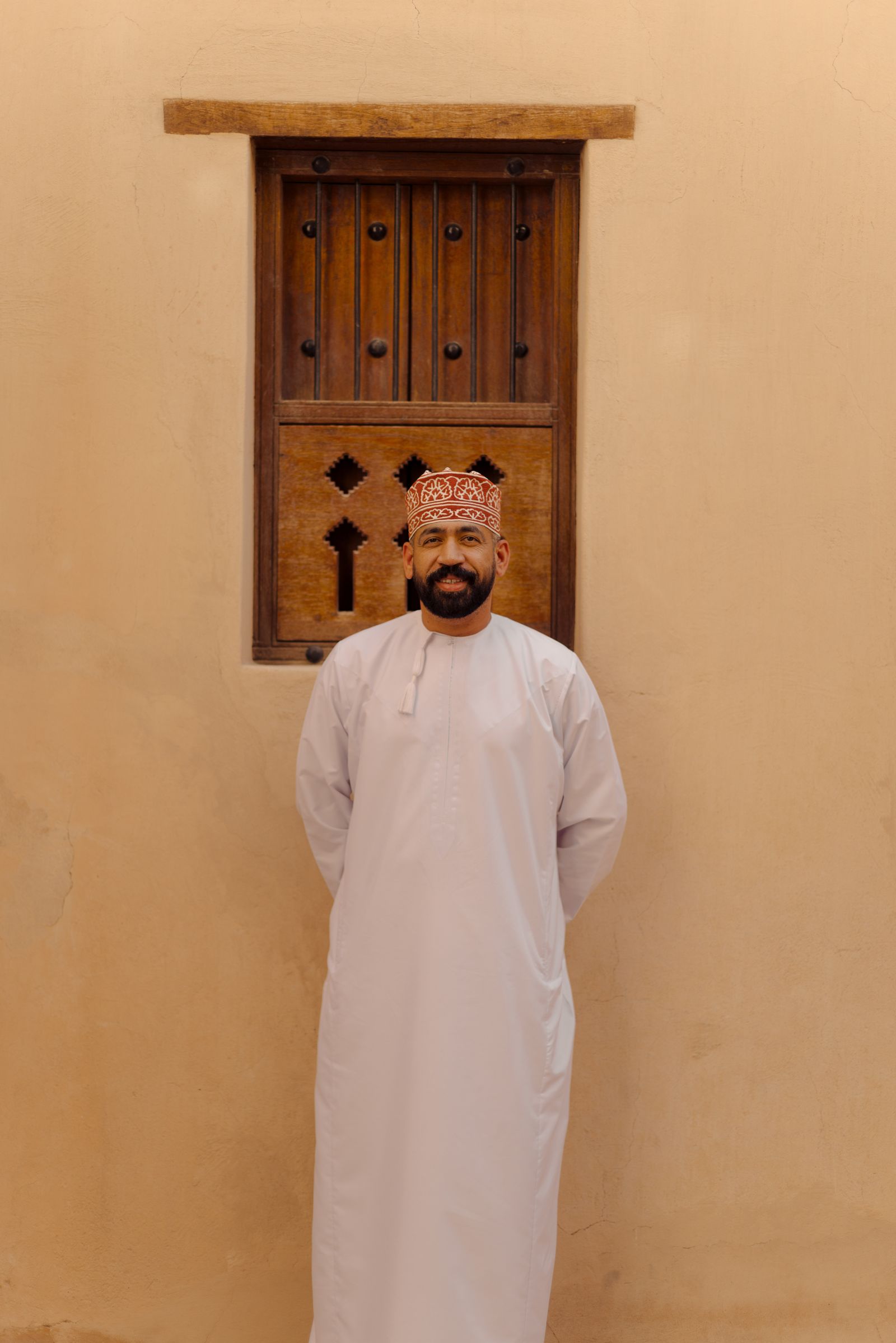 Man in traditional dress using a phone in Dubai